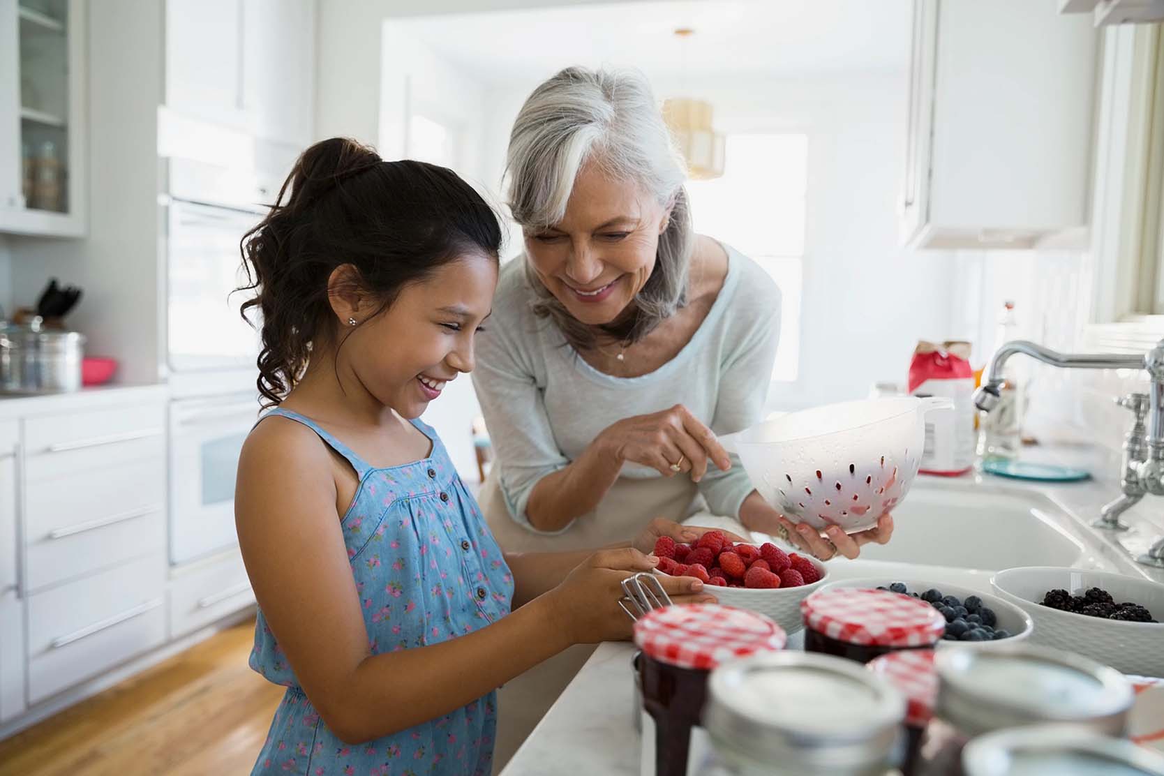 Senior woman makes jam with a girl